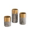 An elegant trio of candle holders in grey marble and brushed brass touches.