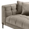 A luxurious sumptuous deep-buttoned sofa with grey velvet upholstery and black legs 