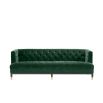 green velvet upholstered deep-buttoned sofa with black legs and brass accents 