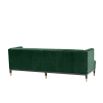 green velvet upholstered deep-buttoned sofa with black legs and brass accents 