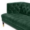 green velvet upholstered deep-buttoned sofa with black legs and brass accents 