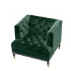 green velvet upholstered deep-buttoned chair with black legs and gold accents 