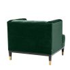 green velvet upholstered deep-buttoned chair with black legs and gold accents 