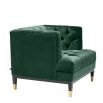 green velvet upholstered deep-buttoned chair with black legs and gold accents 