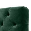 green velvet upholstered deep-buttoned chair with black legs and gold accents 