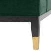 green velvet upholstered deep-buttoned chair with black legs and gold accents 