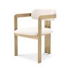 A chic and contemporary brushed brass dining chair upholstered in boucle fabric 