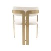 A chic and contemporary brushed brass dining chair upholstered in boucle fabric 