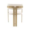 A chic and contemporary brushed brass dining chair upholstered in boucle fabric 