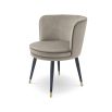 A sophisticated dining chair by Eichholtz with a luxury greige velvet upholstery, swivel seat, black tapered legs and gold capped feet