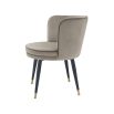 A sophisticated dining chair by Eichholtz with a luxury greige velvet upholstery, swivel seat, black tapered legs and gold capped feet