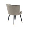 A sophisticated dining chair by Eichholtz with a luxury greige velvet upholstery, swivel seat, black tapered legs and gold capped feet