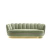 green art deco sofa with brushed brass plinth