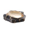 A luxurious rugged bronze bowl with a smooth, polished brass interior