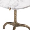 A stylish white marble side table with a hammered antique brass base