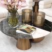 A fabulous round coffee table with a black, white and grey faux marble table top and copped-finished base  