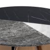 A fabulous round coffee table with a black, white and grey faux marble table top and copped-finished base  
