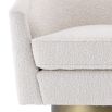 cream coloured boucle swivel chair with matte golden base 