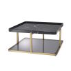 A stylish brushed brass, black marble and smoked glass coffee table