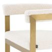 boucle upholstered chair with brushed brass frame