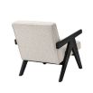 A luxurious boucle armchair with black legs 