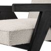 A luxurious boucle armchair with black legs 
