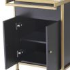 A luxurious dark grey and brushed brass drinks trolley