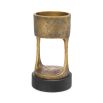 A vintage style brass candle holder with a granite base