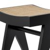 Solid wood stool with black legs and rattan cane webbed seat 