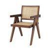 An iconic, brown Jeanneret-inspired dining chair with a rattan seat and backrest