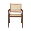 An iconic, brown Jeanneret-inspired dining chair with a rattan seat and backrest