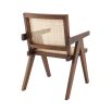 An iconic, brown Jeanneret-inspired dining chair with a rattan seat and backrest