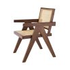 An iconic, brown Jeanneret-inspired dining chair with a rattan seat and backrest