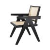 An iconic, black Jeanneret-inspired dining chair with a rattan seat and backrest