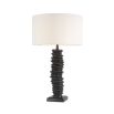 A luxurious bronze table lamp with a natural-toned lampshade