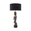 Complete with a black shade, this table lamp boasts an artistic, rocky base that sits on a smooth black base.