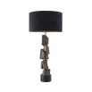 Complete with a black shade, this table lamp boasts an artistic, rocky base that sits on a smooth black base.