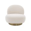 A luxurious boucle armchair with a brushed brass swivel base
