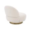 A luxurious boucle armchair with a brushed brass swivel base