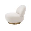 A luxurious boucle armchair with a brushed brass swivel base