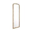 An elaborate vintage brass wall mirror with intricate leaf detailing