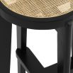 A chic black Scandinavian-inspired bar stool with rattan cane webbing