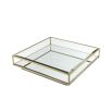 A contemporary glass coffee table with a brushed brass finish