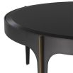 A contemporary chic coffee table by Eichholtz with a round black bevelled glass top, bronze frame and brass accents