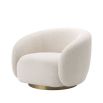 A sumptuous art deco inspired armchair with a brushed brass swivel base