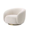 A sumptuous art deco inspired armchair with a brushed brass swivel base