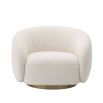 A sumptuous art deco inspired armchair with a brushed brass swivel base