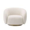 A sumptuous art deco inspired armchair with a brushed brass swivel base