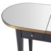 A luxurious, grey charcoal dressing table with brass details and a mirrored surface