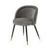 A luxurious set of two velvet dining chairs with black tapered legs and golden caps